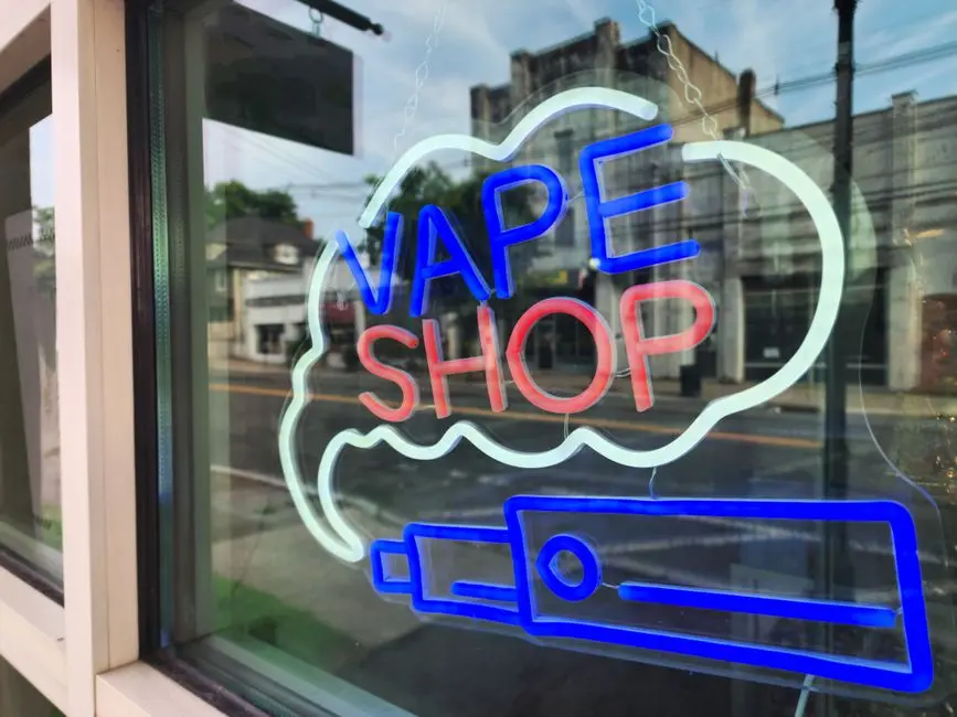 Customer browsing vape products at Rollin EZ Tobacco store